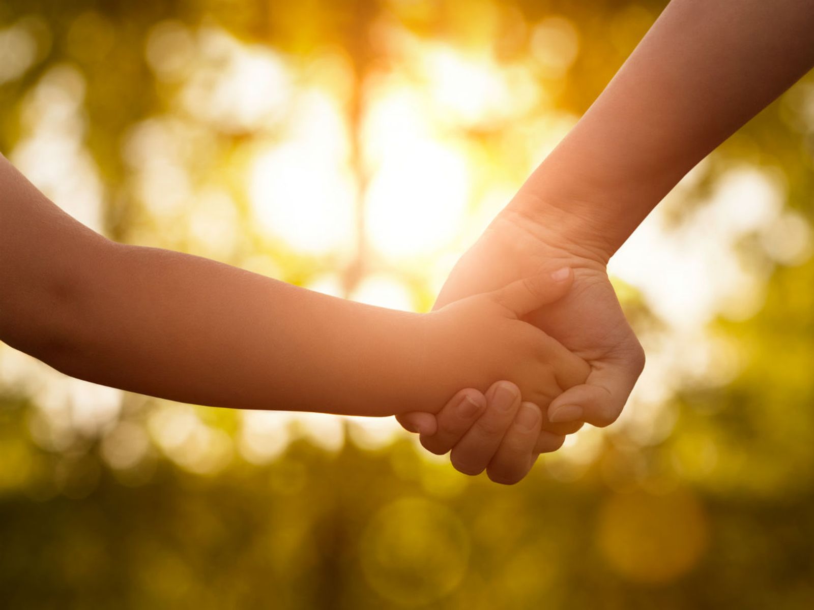 Mother guiding child hand